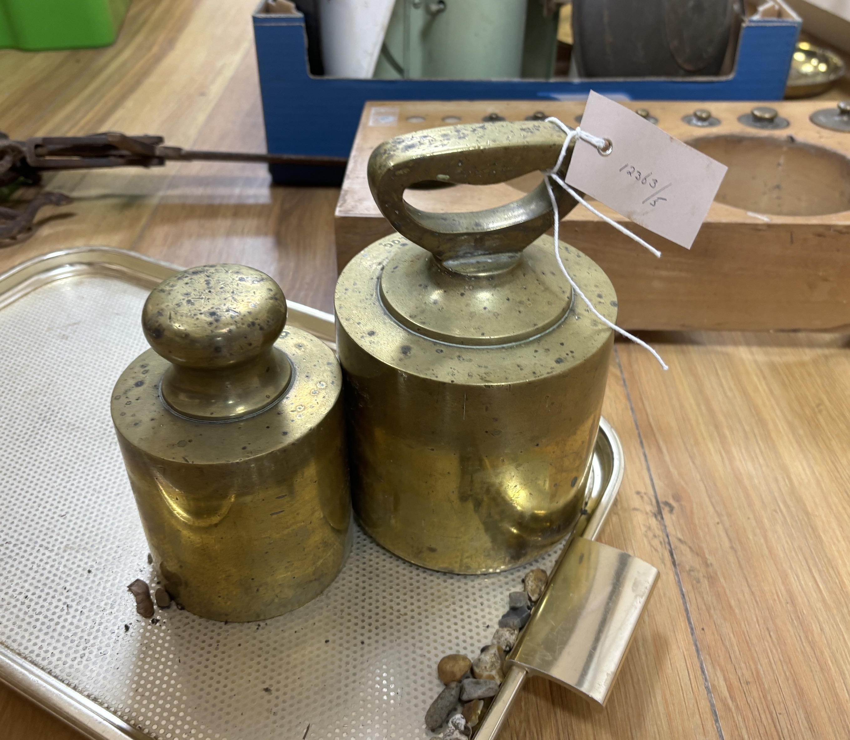 A large graduated part set of weights in wooden stand and other scales and steelyard, wooden base 47cm wide